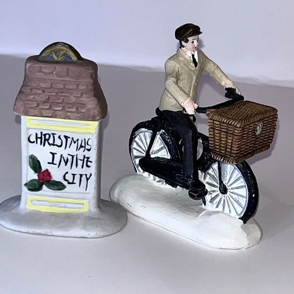2 Christmas‎ Village Ceramic Figurines Man On Bicycle & Christmas In City Sign